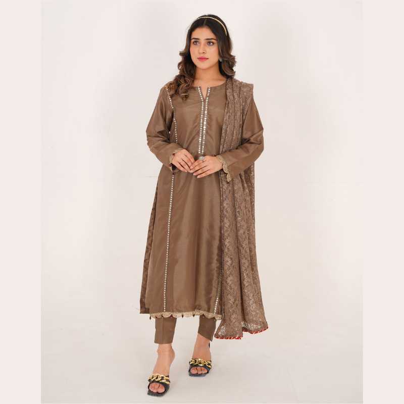 3-piece Brown Raw Silk Dress with Net Dupatta and matching raw silk trousers.
